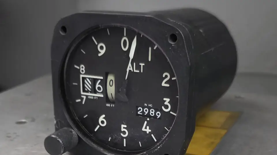 Aircraft altimeter on a workbench in the CIA instrument shop