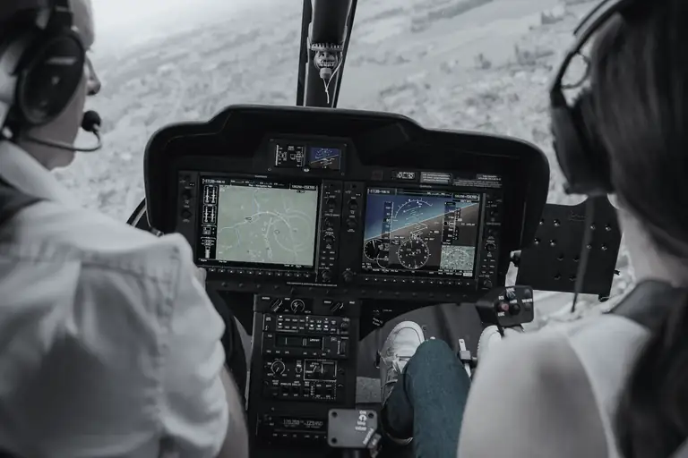 Garmin glass-cockpit displays and radios in a helicopter instrument panel, in flight