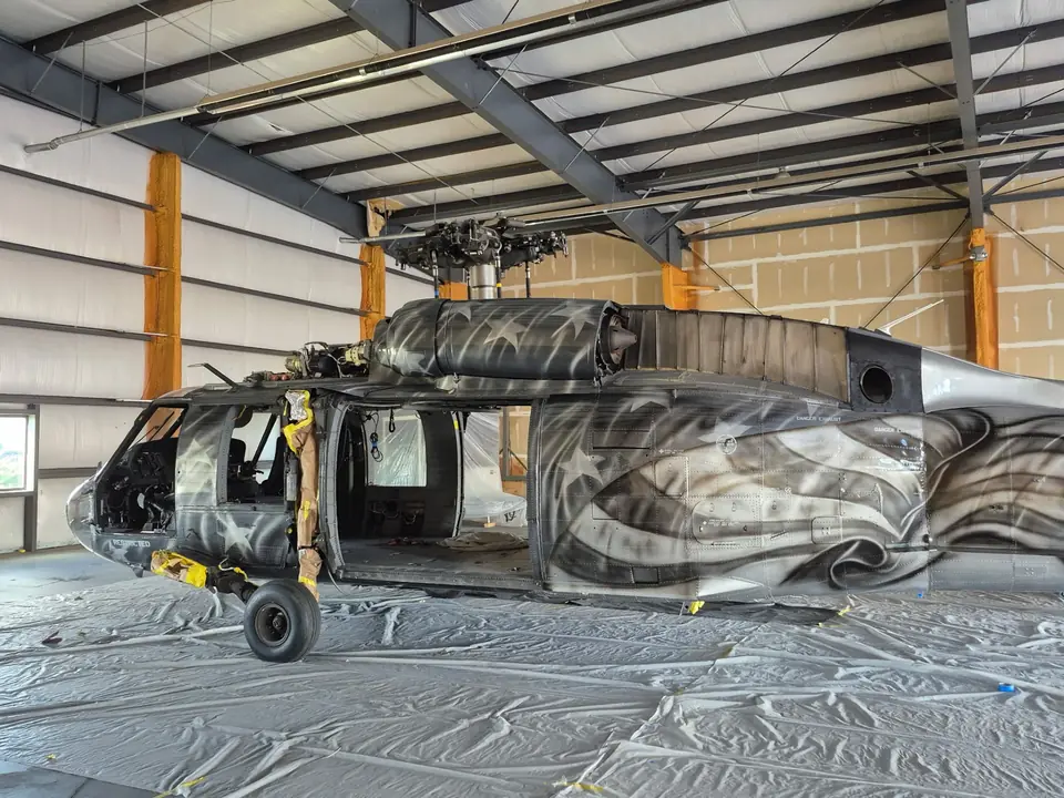 UH-60 Black Hawk in the CAS paint hangar, with a custom flag-and-eagle livery in progress