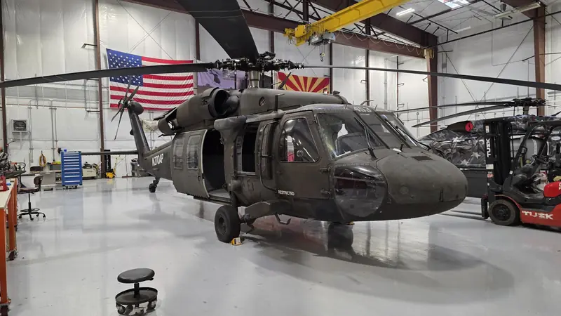 UH-60 Black Hawk in a hangar under the US and Arizona flags