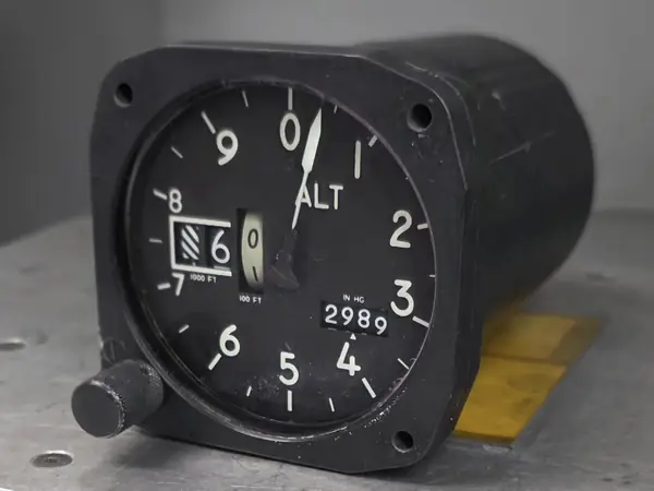 Aircraft altimeter on a metal workbench