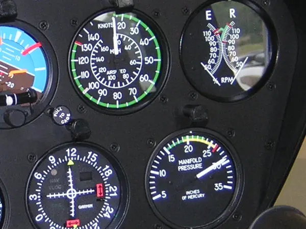 Dual engine and rotor tachometer and manifold pressure gauge beside the airspeed indicator in a Robinson R44 panel