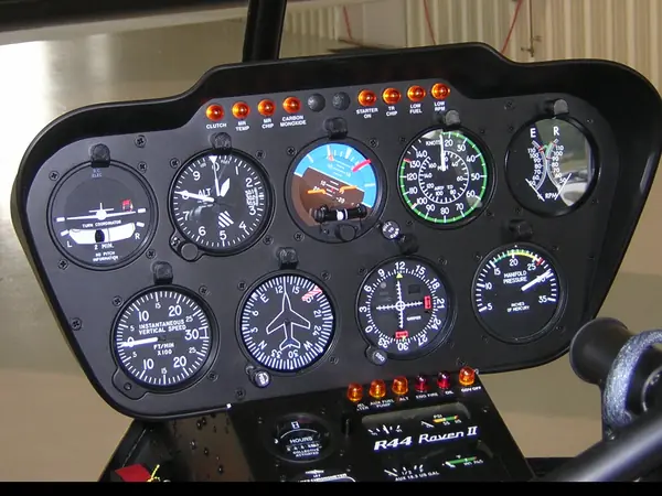 Round-dial flight instruments in a Robinson R44 helicopter panel