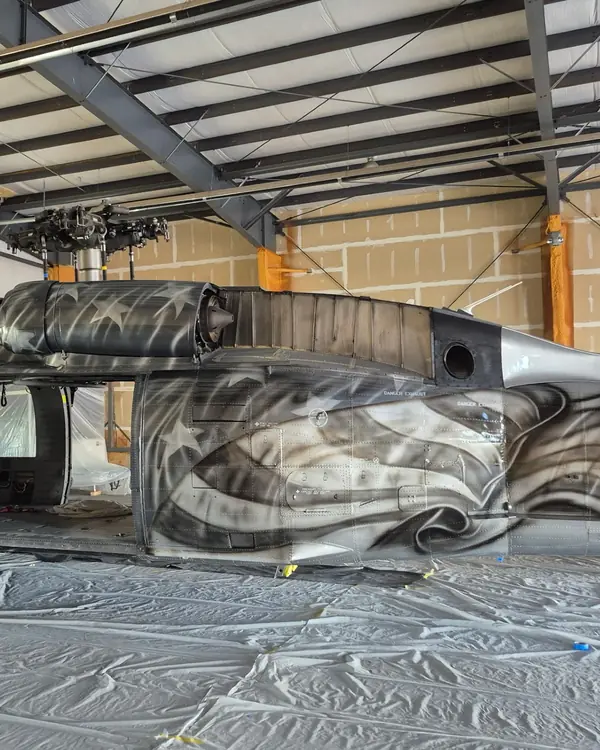 UH-60 Black Hawk in the CAS paint hangar, with a custom flag-and-eagle livery in progress